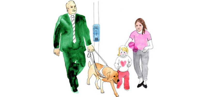 En kostymklädd man med ledarhund går förbi ett övergångsställe. Där står en kvinna med ett barn.